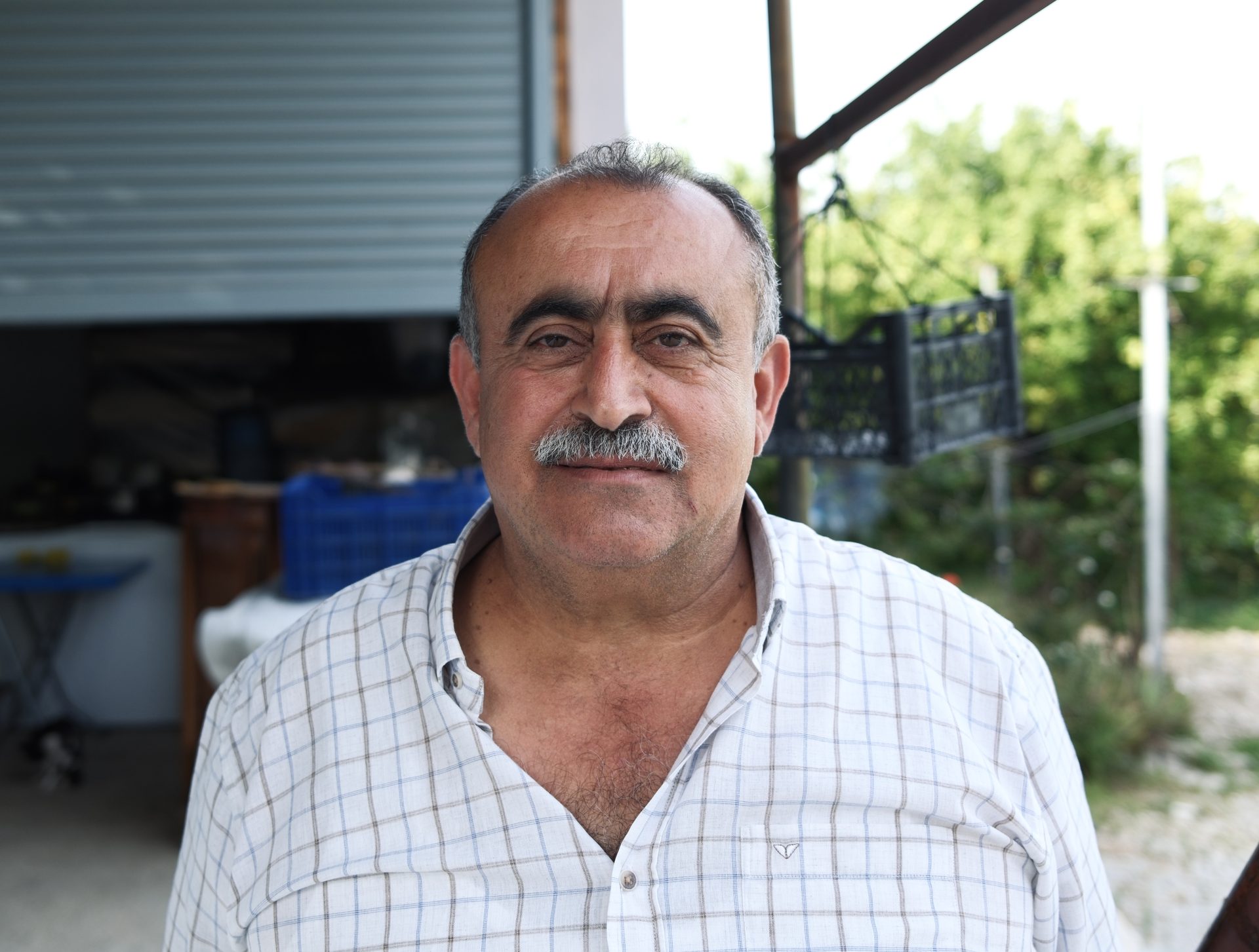 Portrait of the village chief of Vakıflı in front of his workshop