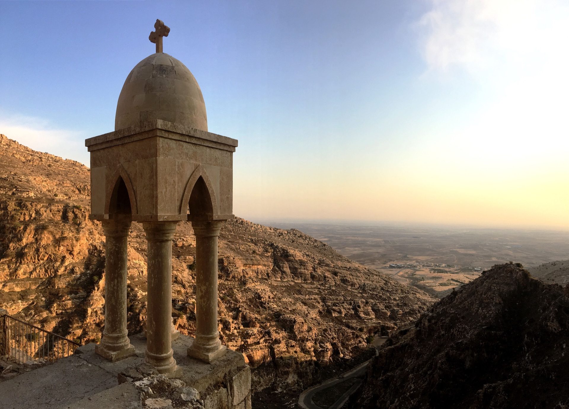 The bell-cupola of Rabban Hormizd monastery at golden hour, overlooking the Nineveh plain below