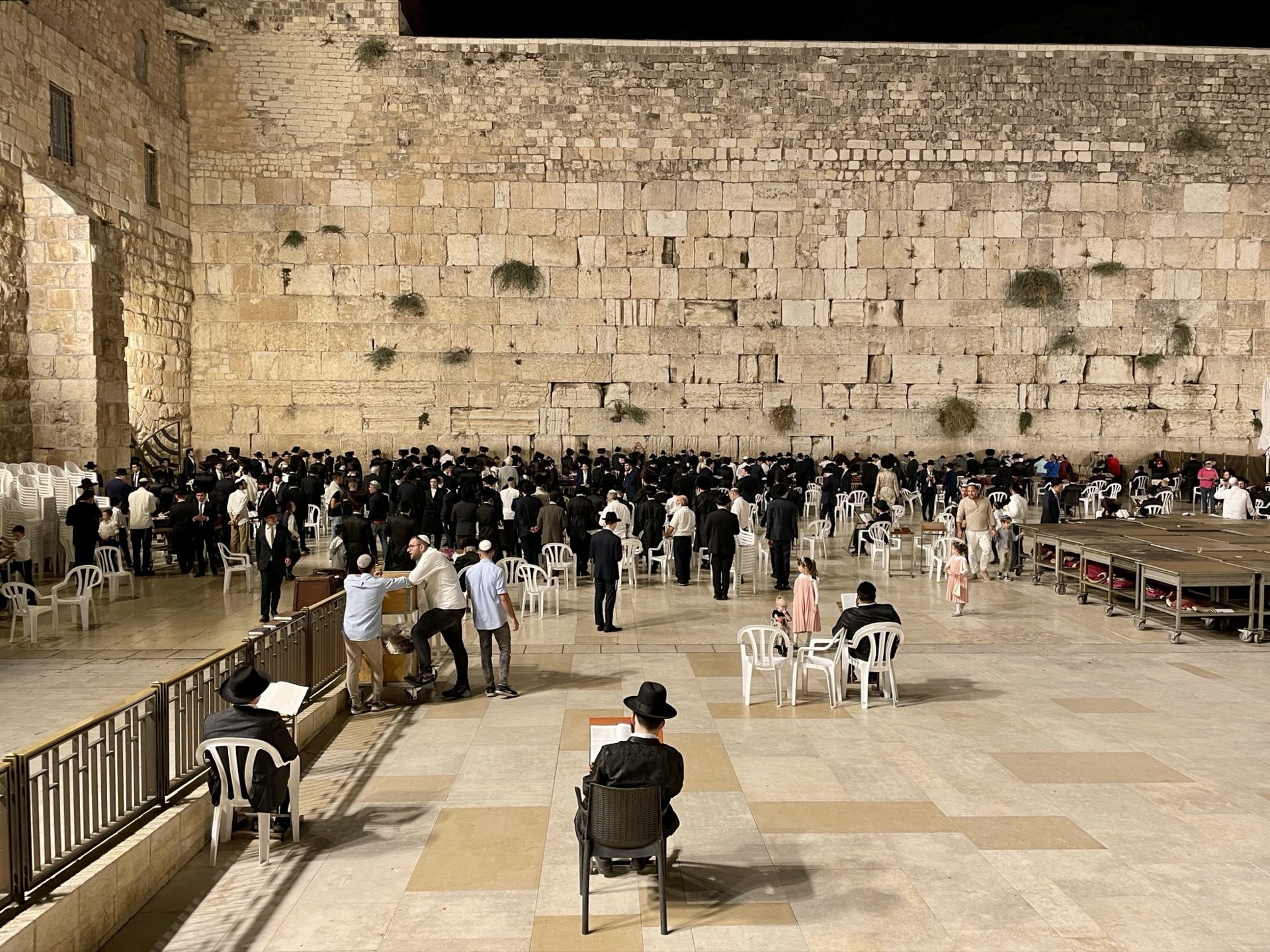 Orthodox Jews praying at the floodlit Western Wall at night