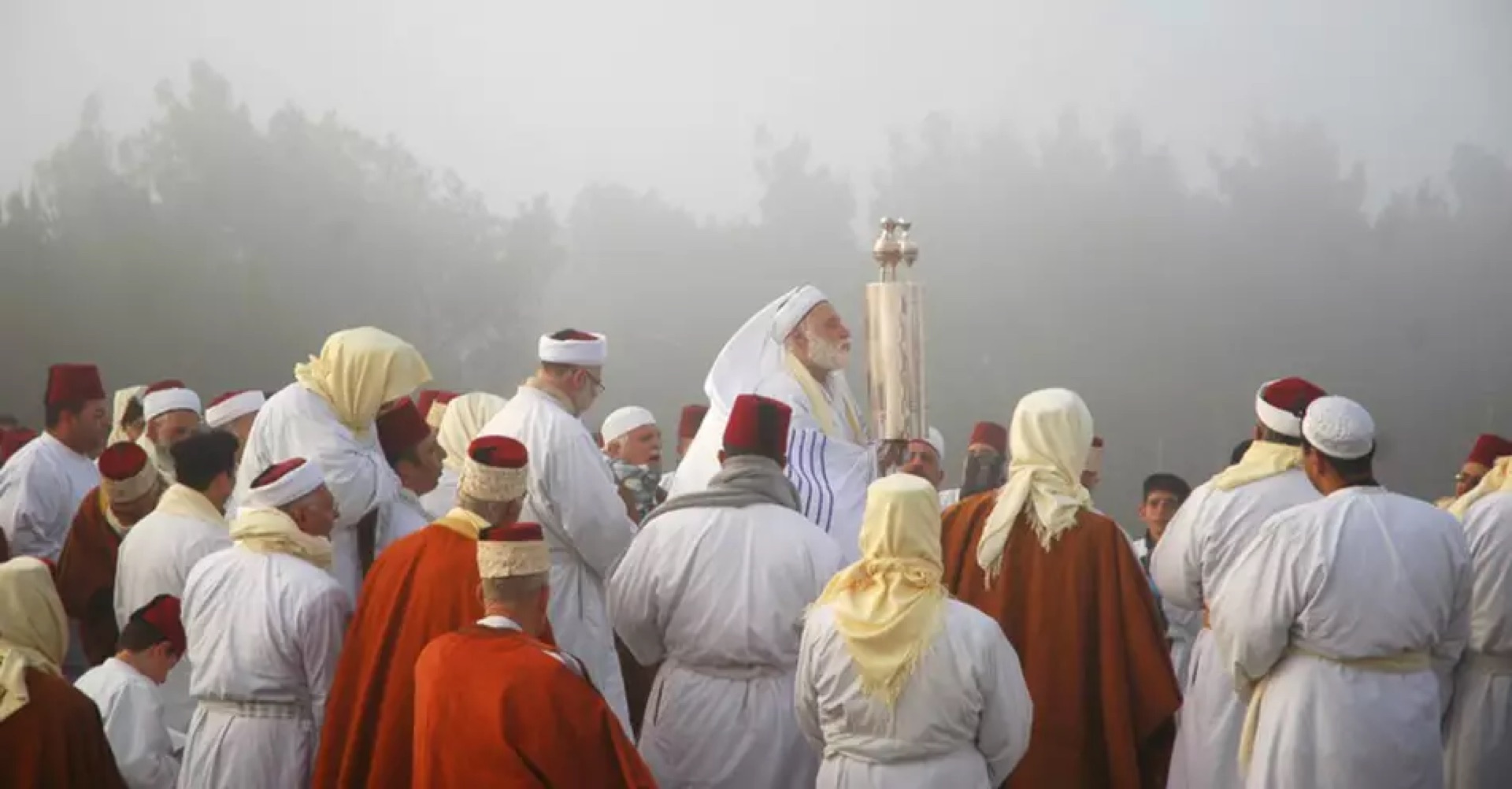Samaritan priests in robes holding the community's ancient Torah scrolls
